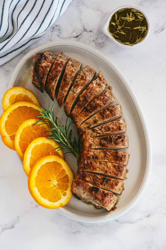 Orange Mustard Pork Tenderloin - This easy glazed tenderloin recipe is sweet and savory with orange juice and stone ground mustard. You'll never have a dry piece of pork with this homemade marinade.