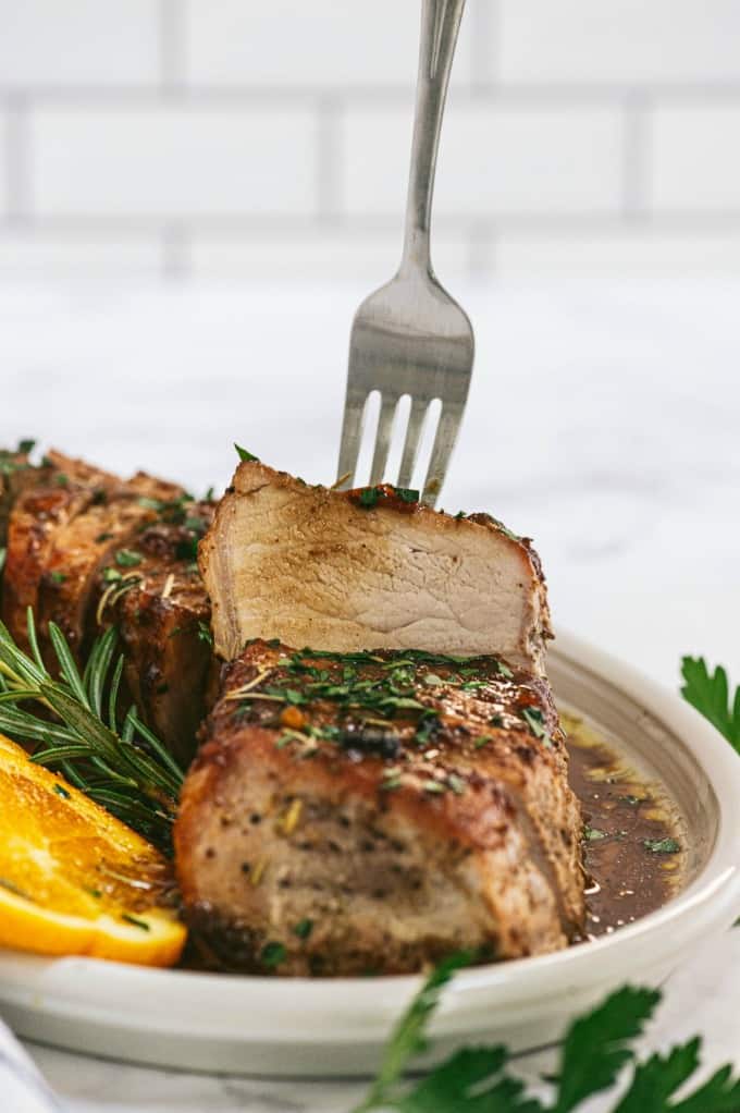 Orange Mustard Pork Tenderloin - This easy glazed tenderloin recipe is sweet and savory with orange juice and stone ground mustard. You'll never have a dry piece of pork with this homemade marinade.