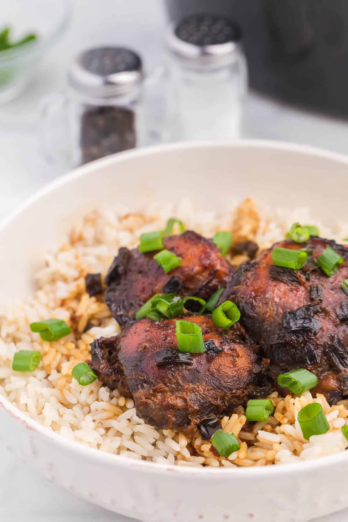 Peking chicken served on rice in a bowl.