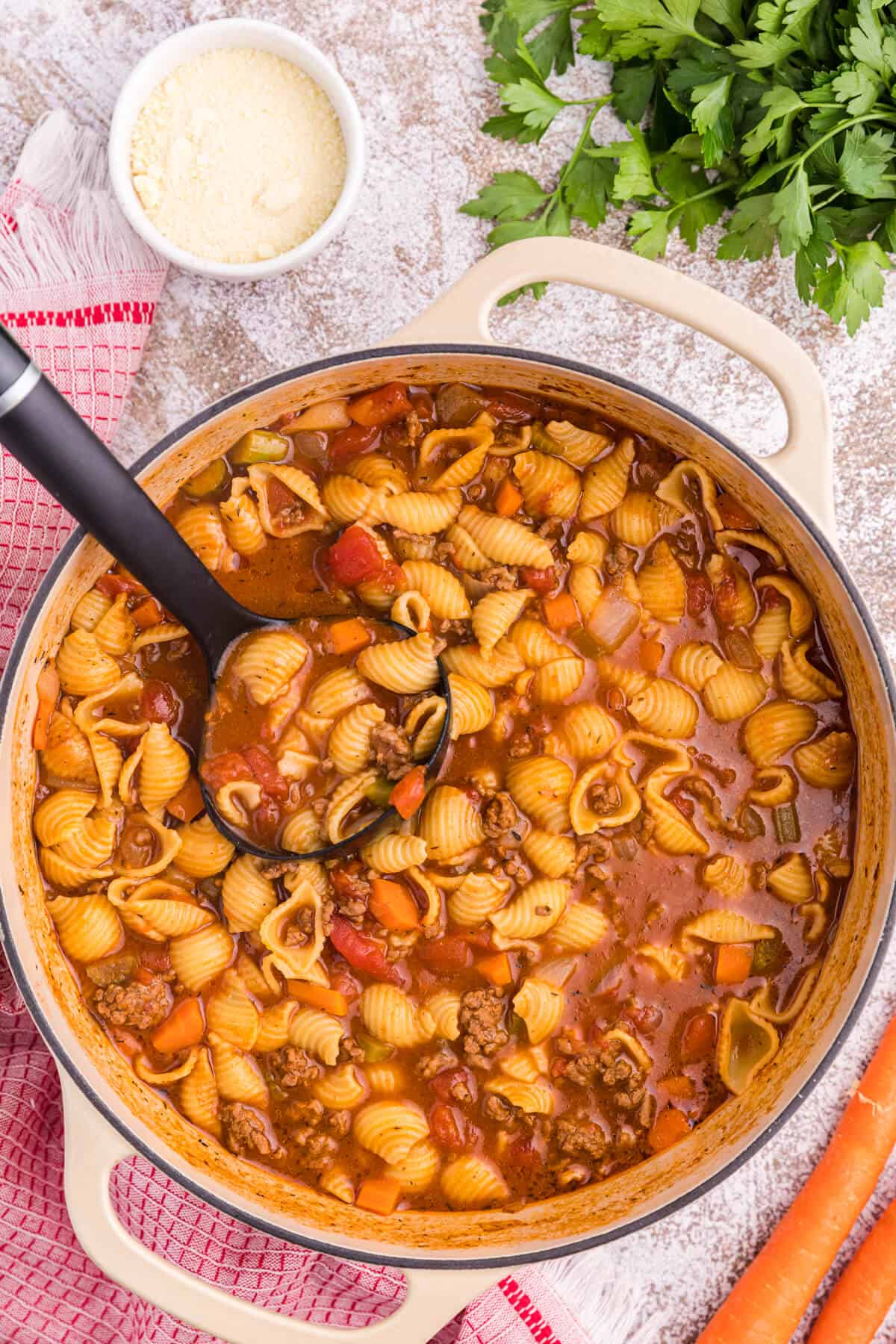 Hamburger soup in a pot with a ladle.