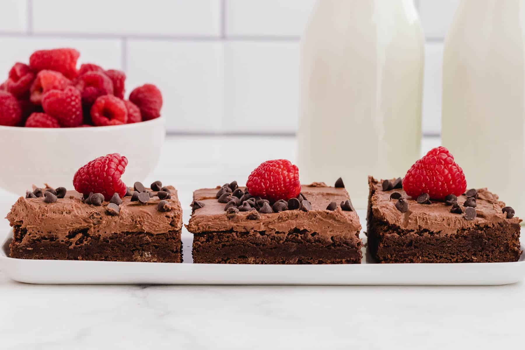 A plate of three chocolate raspberry brownies.