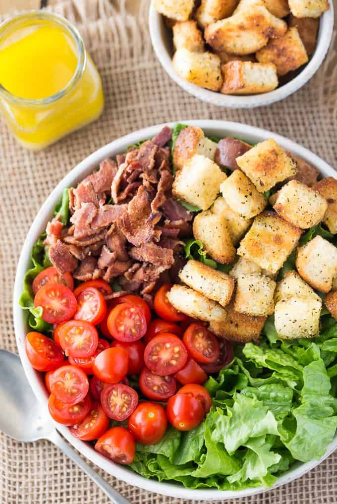 BLT Salad - Try your favourite sandwich as a salad! You'll love the fresh lettuce, juicy tomatoes and crisp bacon topped with savoury croutons and Honey Dijon Vinaigrette.