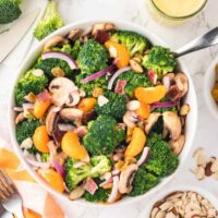 Broccoli salad in a bowl with a spoon.