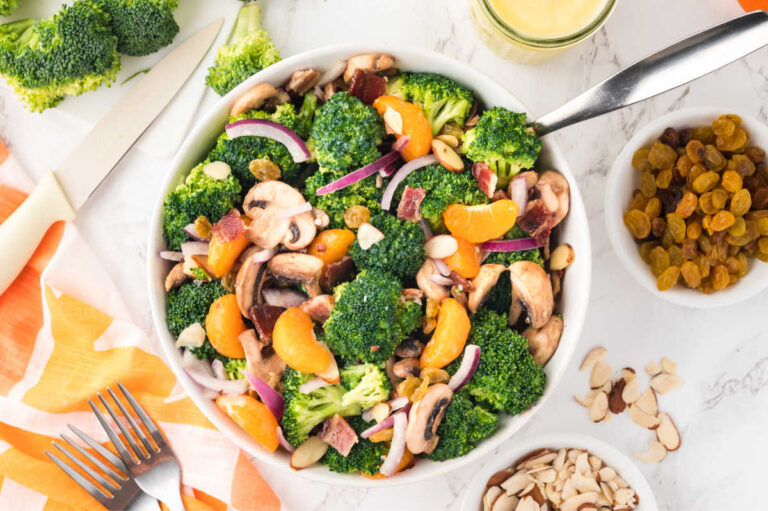 Broccoli salad in a bowl with a spoon.