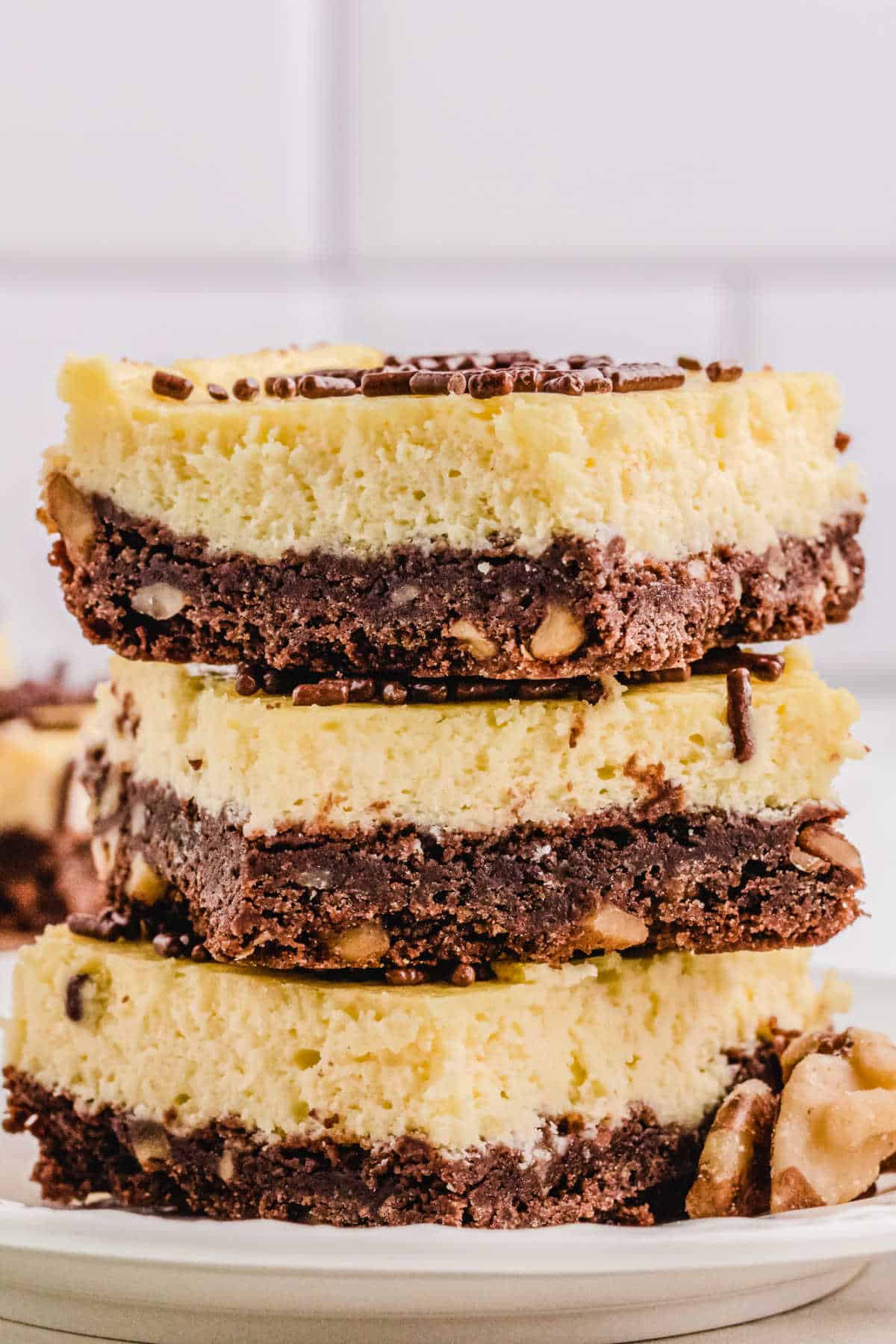 A stack of 3 cheesecake squares.