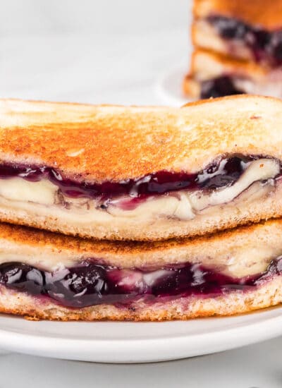 A blueberry brie grilled cheese on a plate.