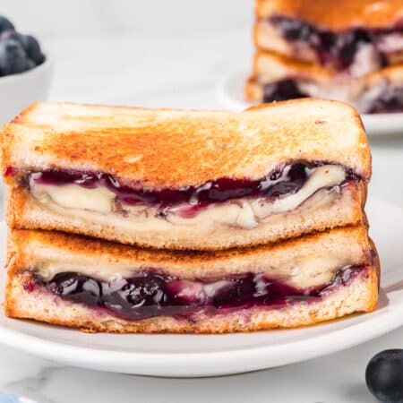 A blueberry brie grilled cheese on a plate.