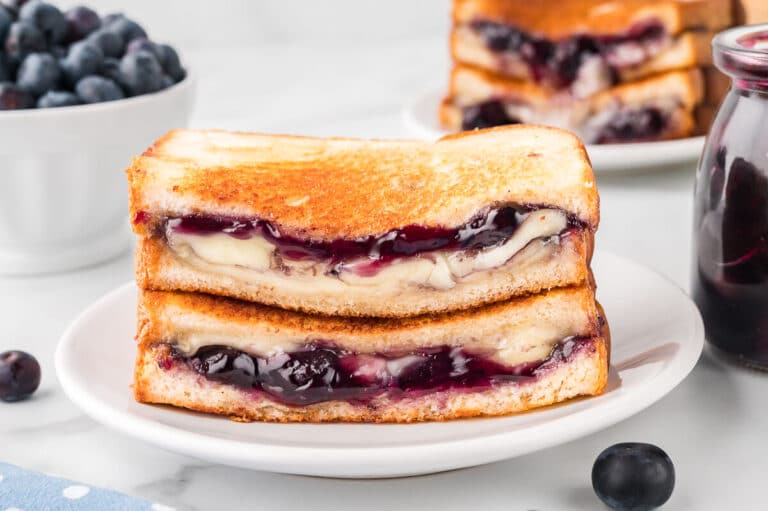 A blueberry brie grilled cheese on a plate.