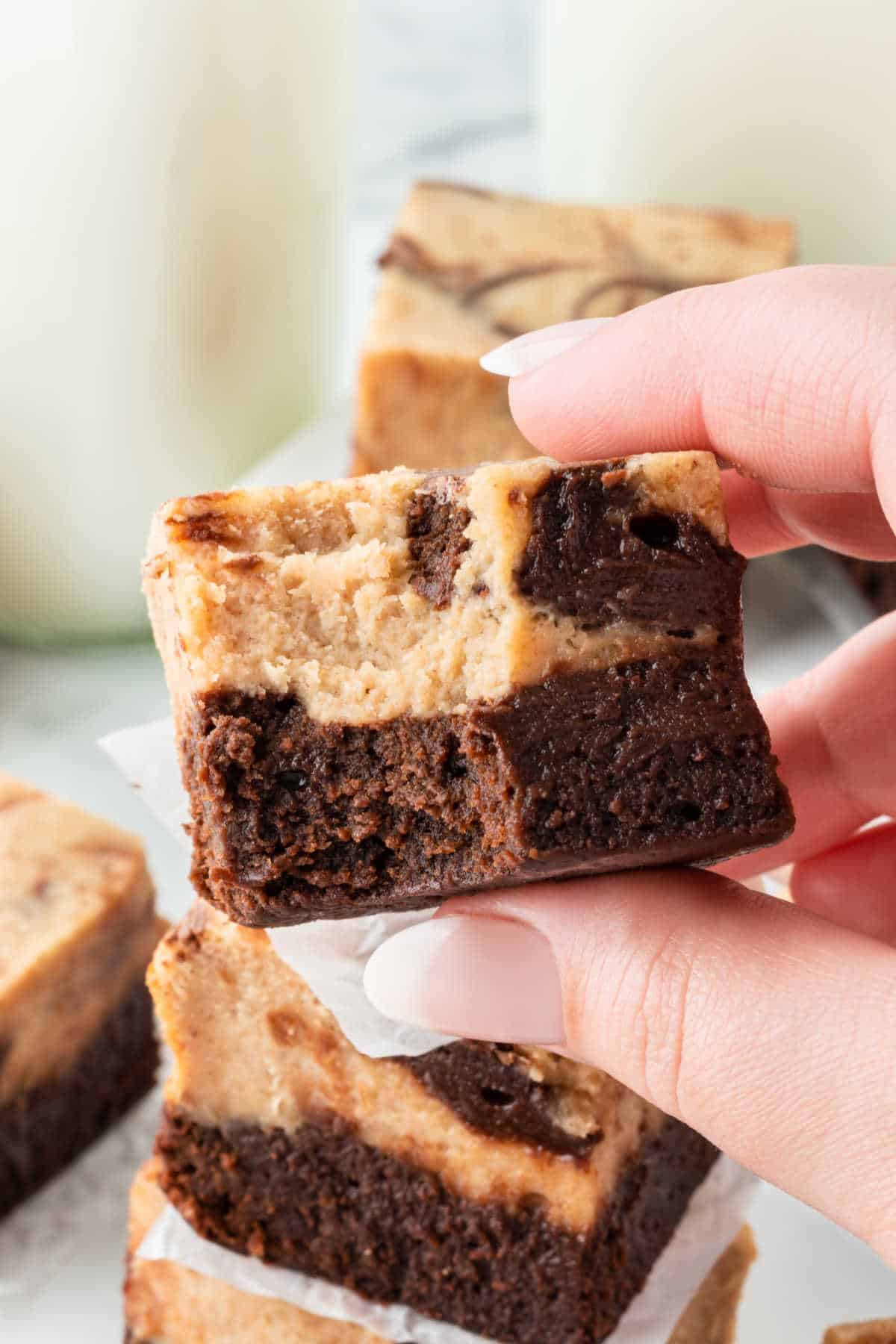 A peanut butter cheesecake brownie with a bite out of it.