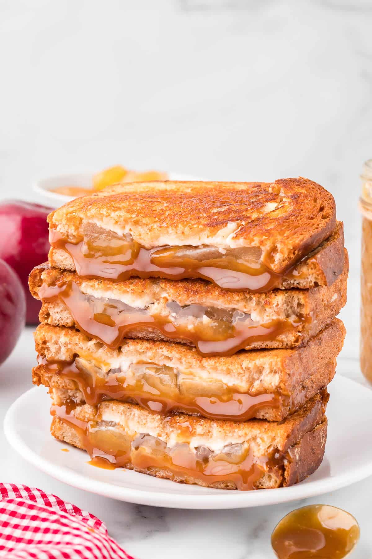 Caramel apple grilled cheese stacked on a plate.