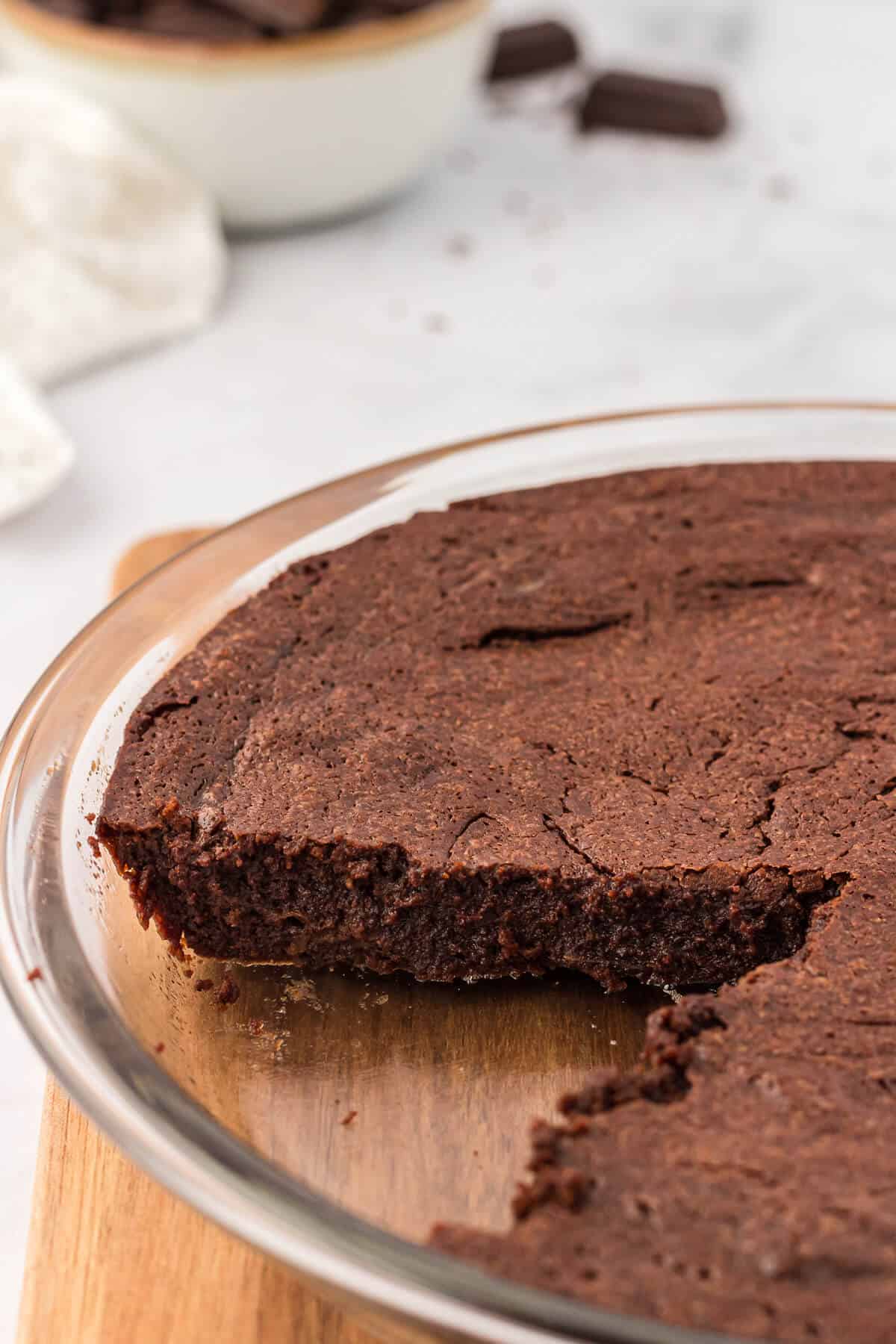 A fudge pie with a piece cut out.