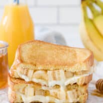 Honey Banana Grilled Cheese Stacked on a cutting board.