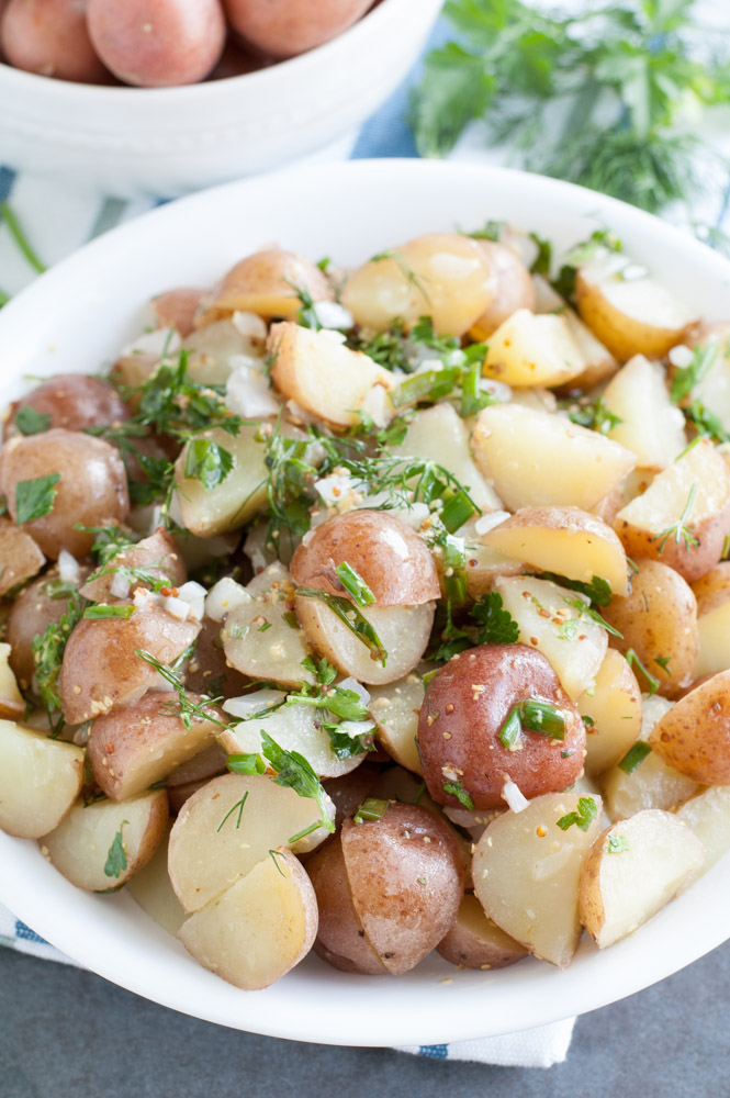 Herb Potato Salad - Keep it clean with this dairy-free potato salad! This easy side dish recipe feels fancy with fresh herbs and red potatoes.