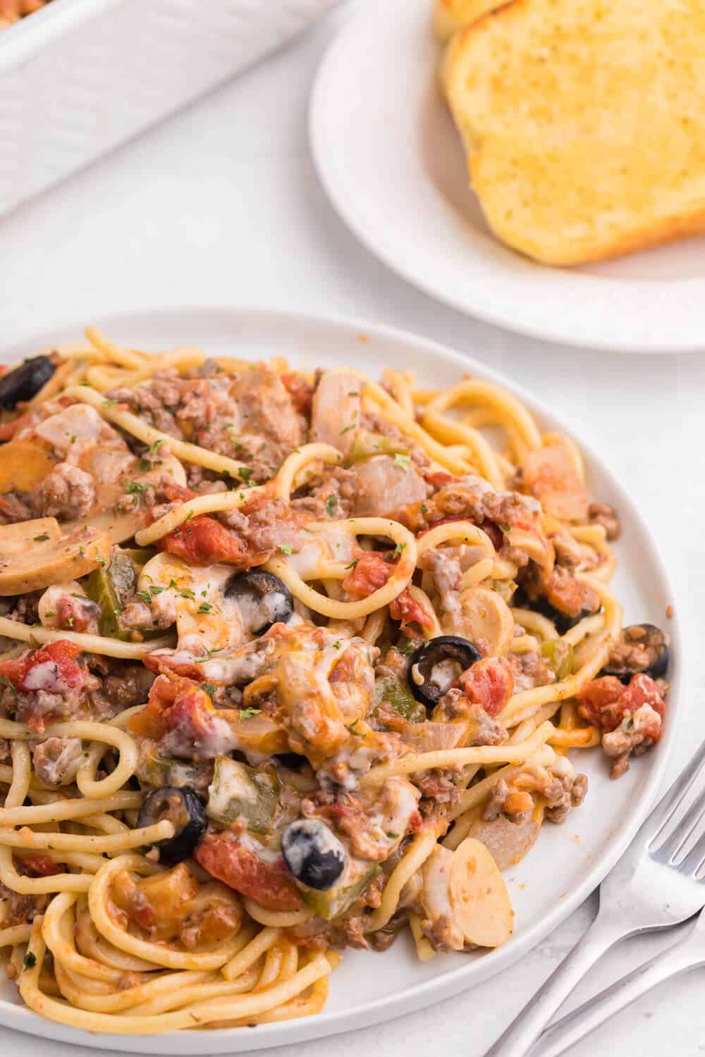 Spaghetti Casserole - Layered pasta, creamy mushroom sauce, diced tomatoes, mushrooms and olives are combined to make a perfect weekend supper.