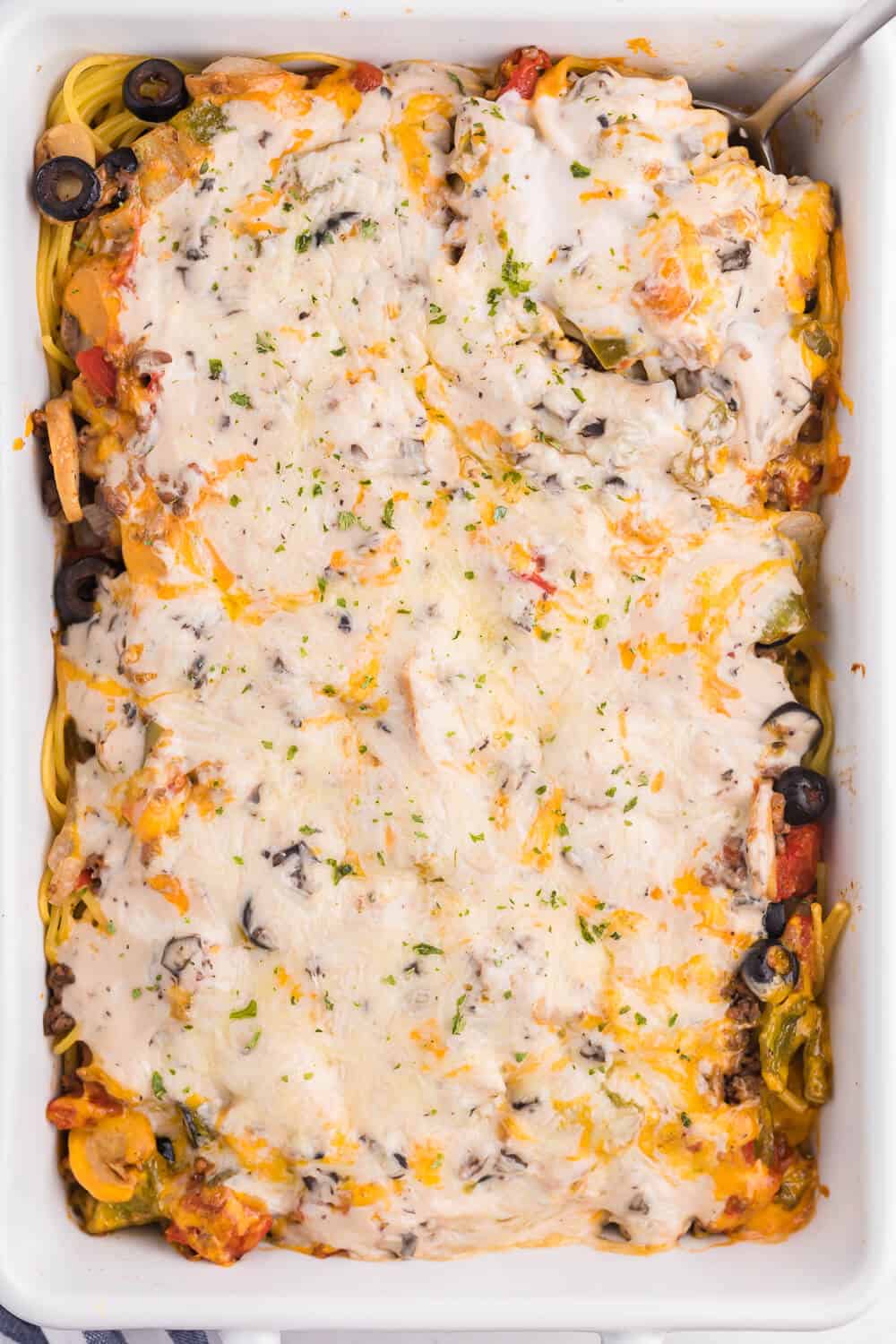 Spaghetti Casserole - Layered pasta, creamy mushroom sauce, diced tomatoes, mushrooms and olives are combined to make a perfect weekend supper.