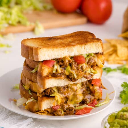 Taco Grilled Cheese stacked on a plate.
