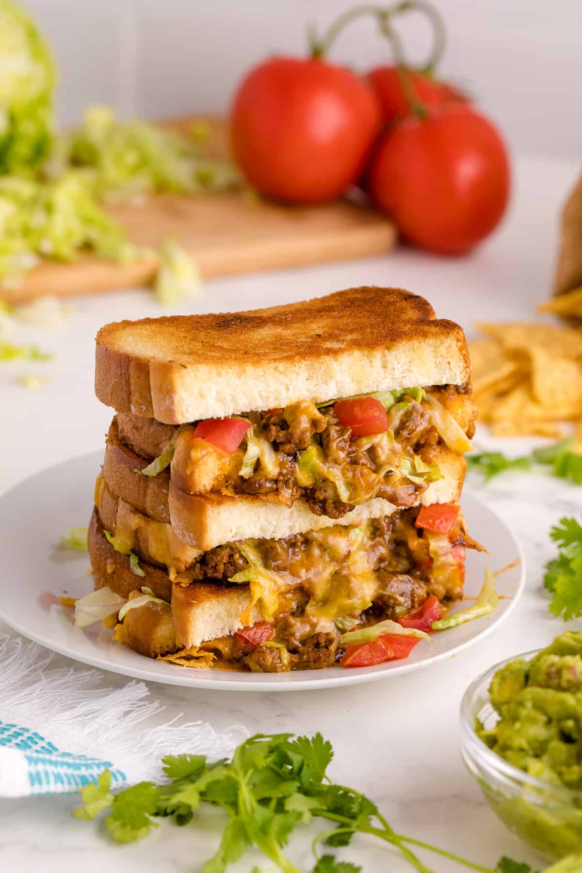 Taco Grilled Cheese stacked on a plate.