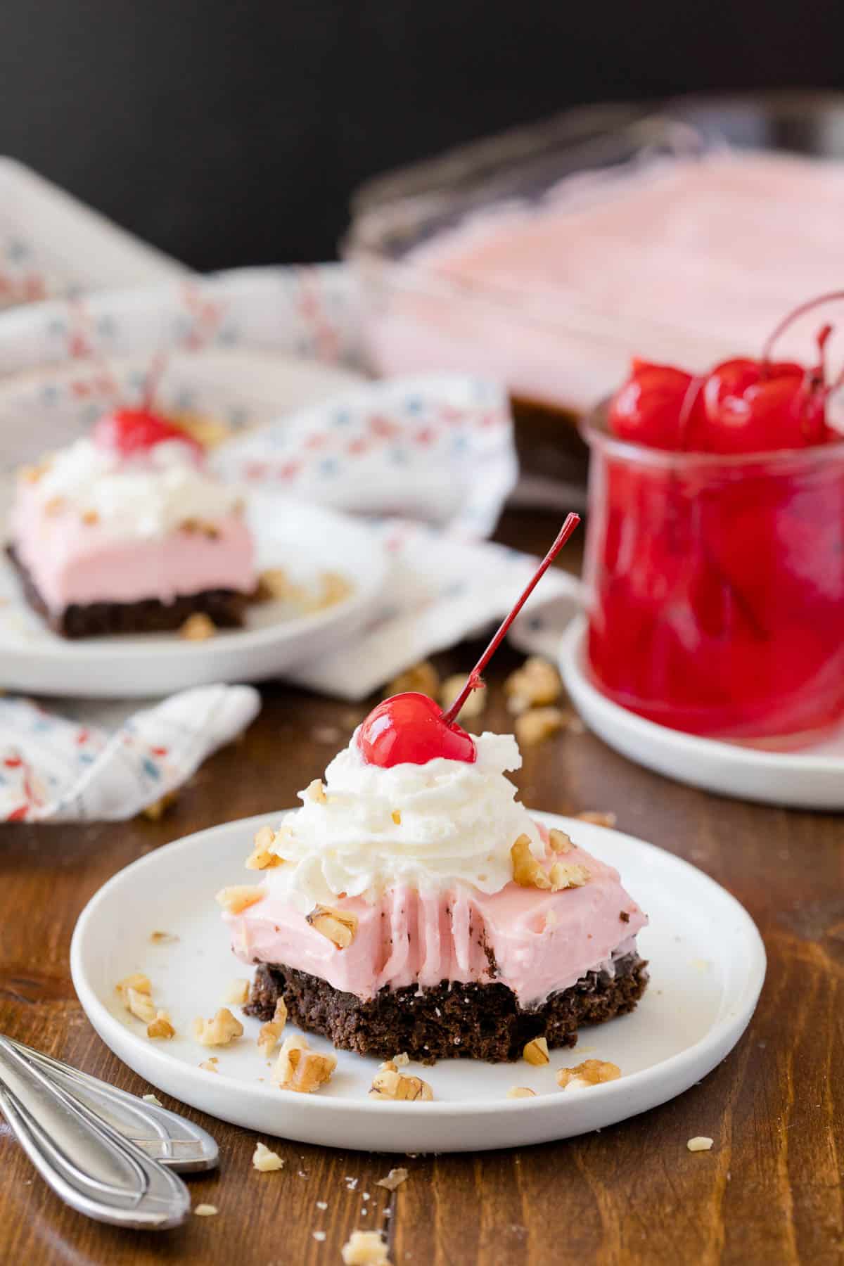 a piece of banana split brownies on a plate with a bite take out of it