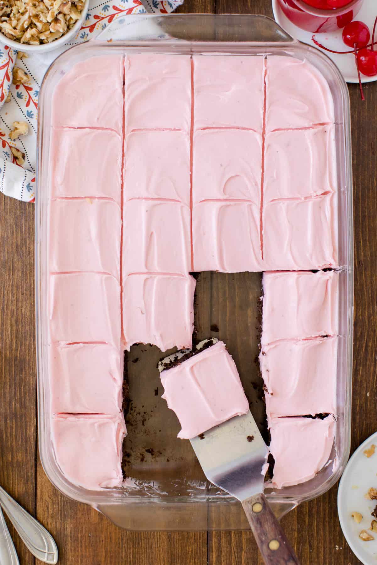 banana split brownies in a casserole dish with slices cut and a piece on a spatula