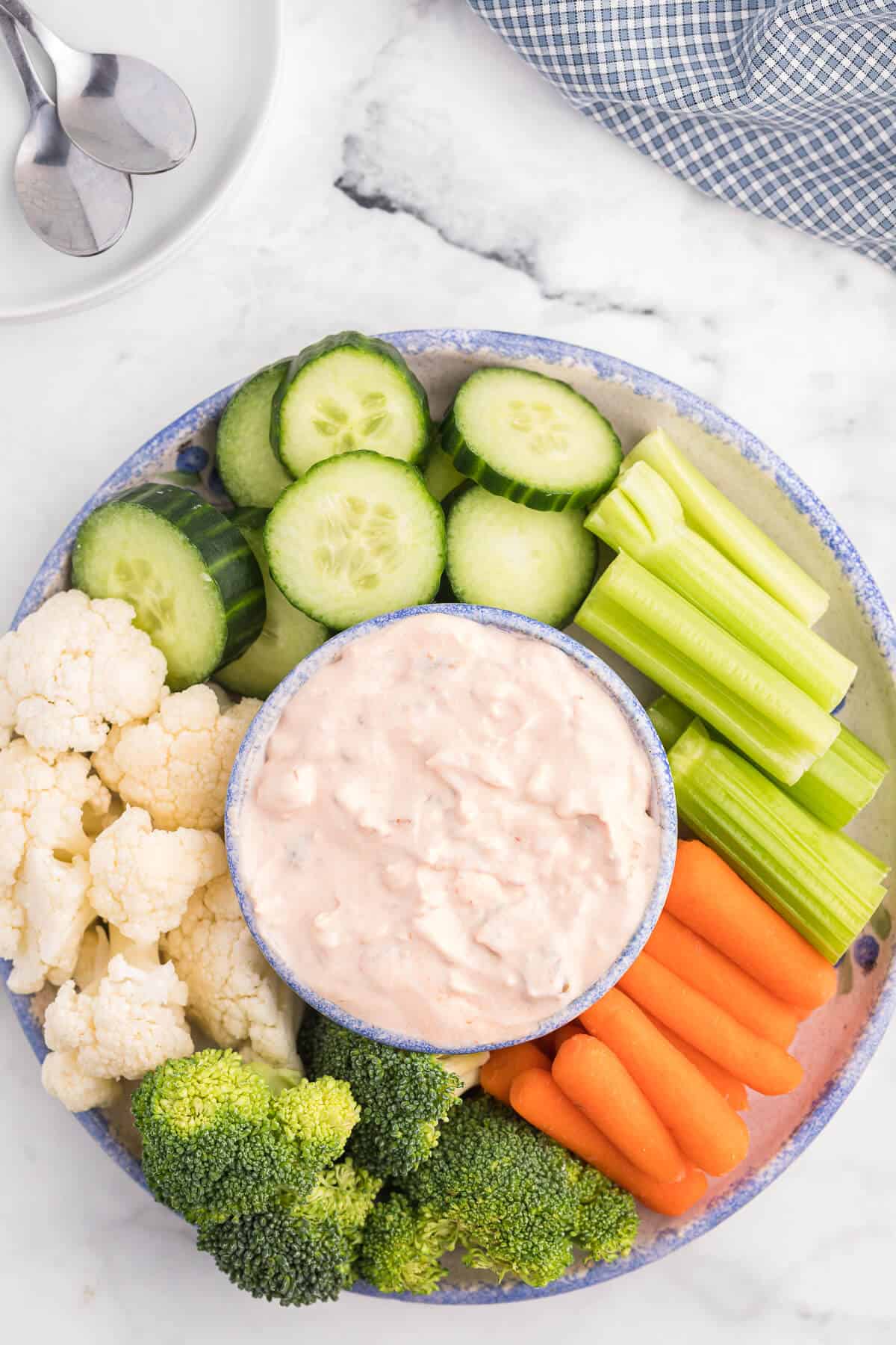 Veggies and creamy salsa dip on a platter.