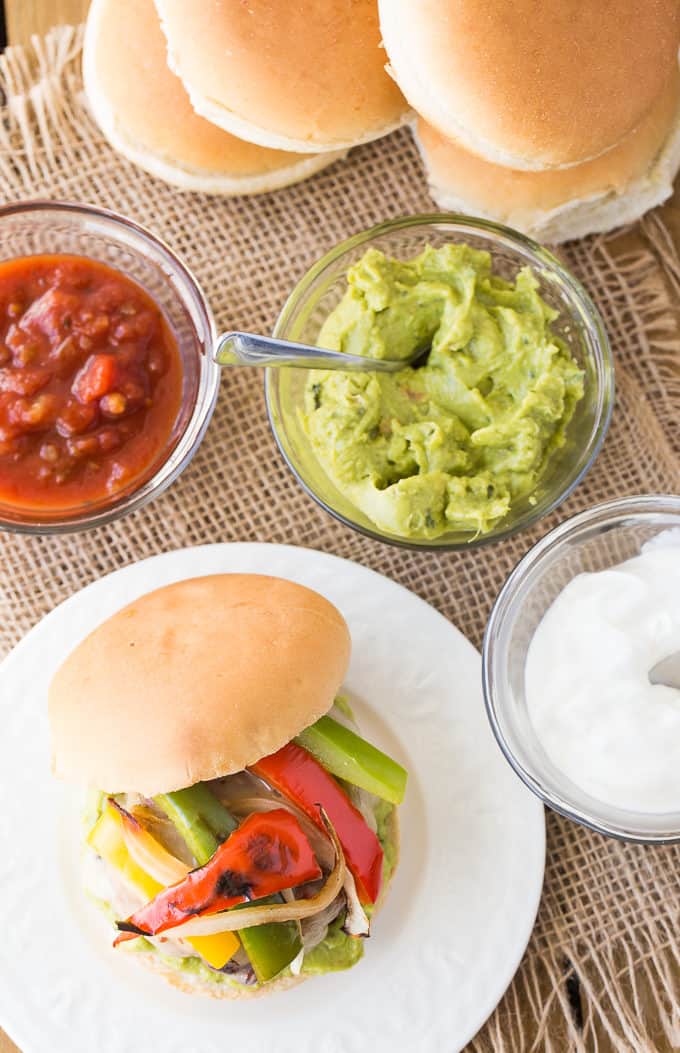 Chicken Fajita Burgers - Skip the beef for this barbecue recipe! These lean cheeseburgers are topped with your favorite fajita veggies and all the spices.