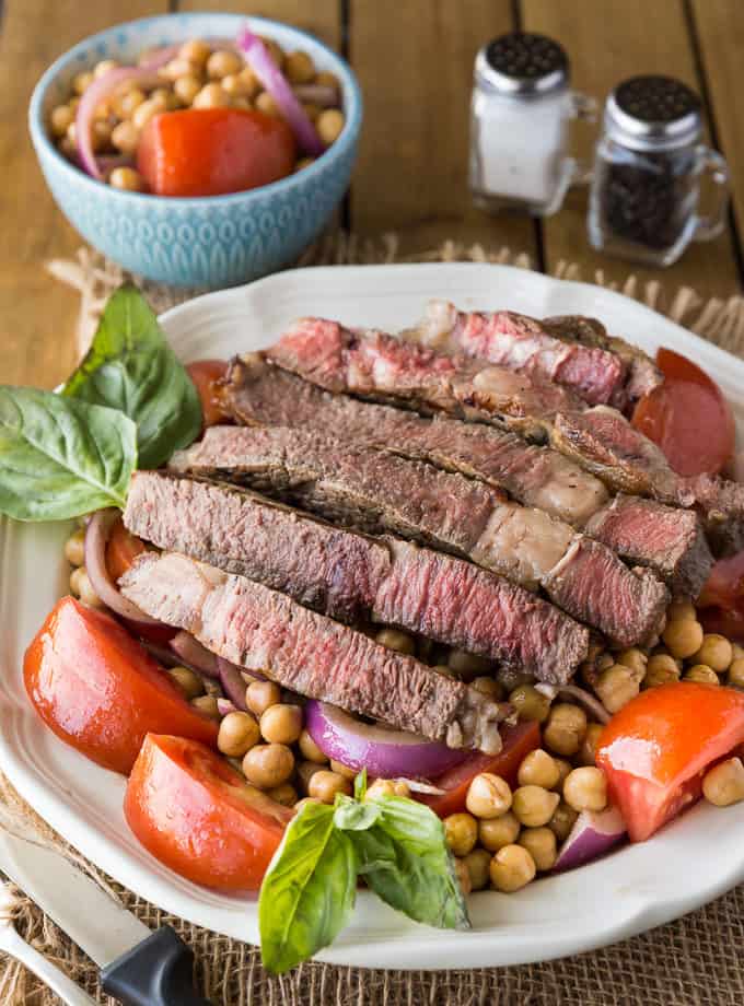 Mediterranean Style Grilled Rib Steak - Tender, juicy rib steak is sliced and nestled in with a fresh garbanzo bean salad. 