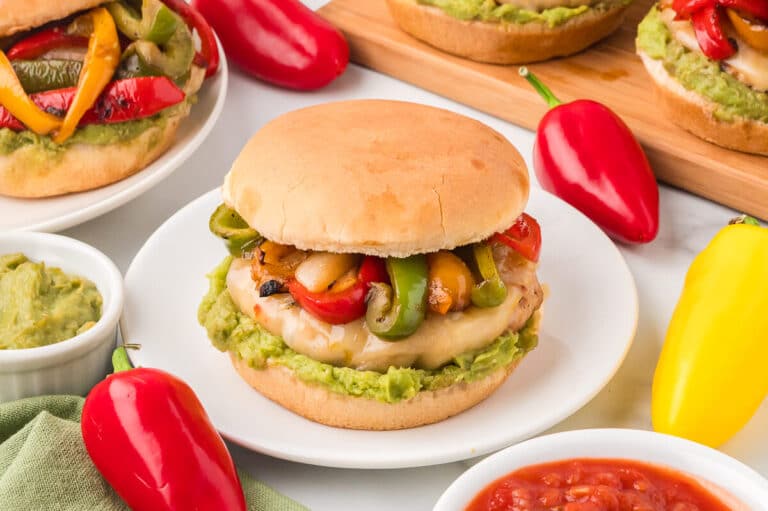 A chicken fajita burger on a plate.