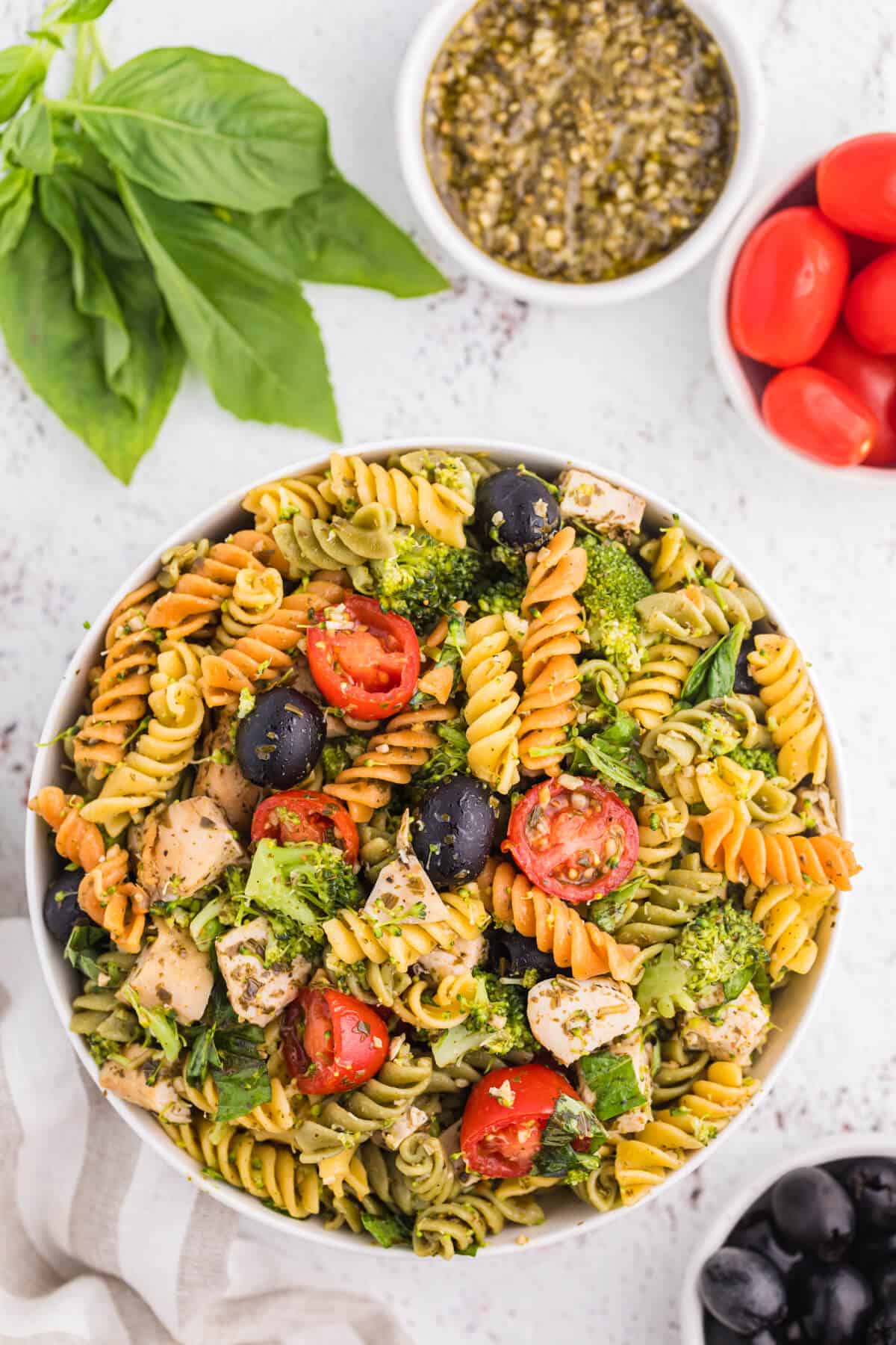 Pesto chicken pasta salad in a bowl.