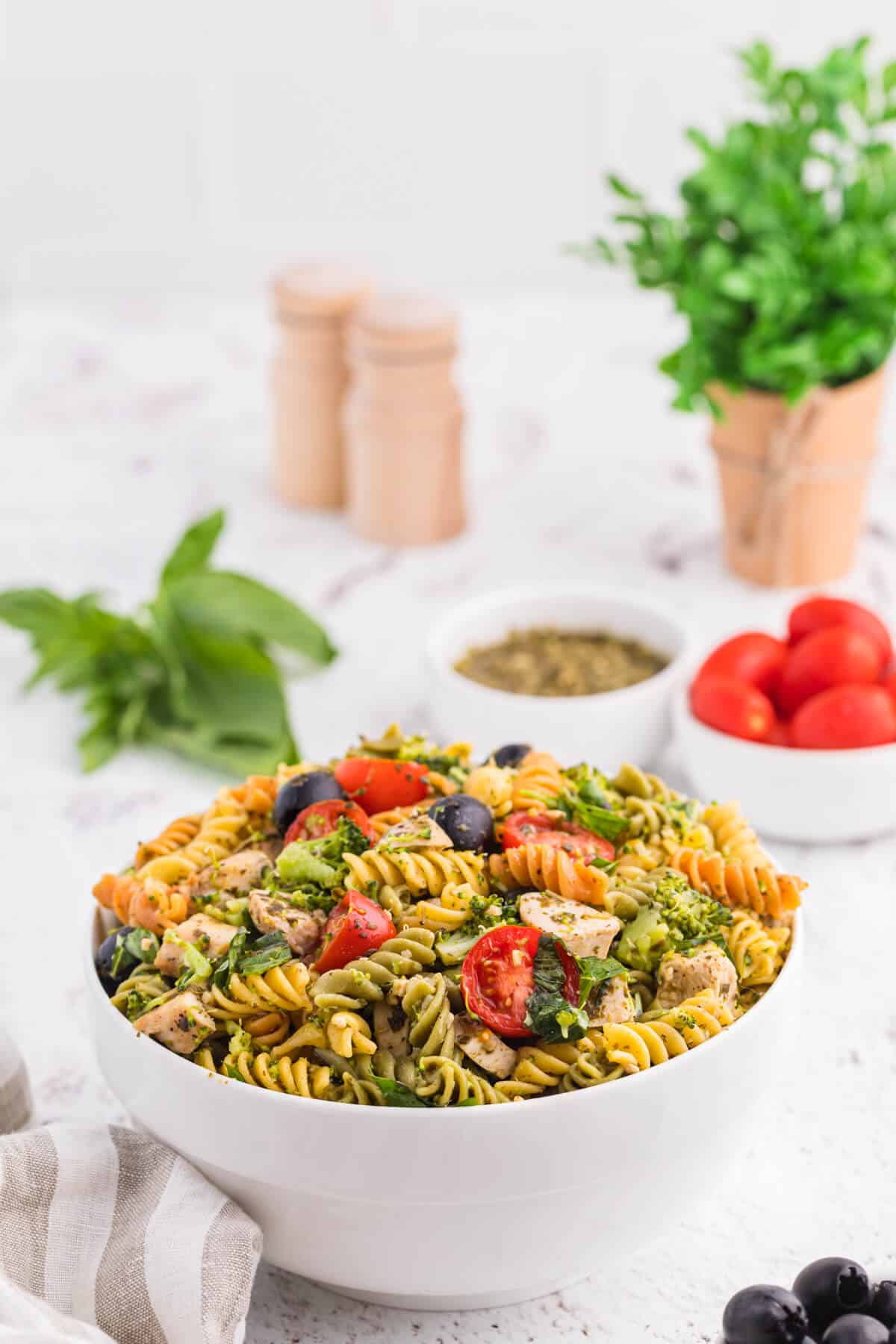 Pesto chicken salad in a white bowl.