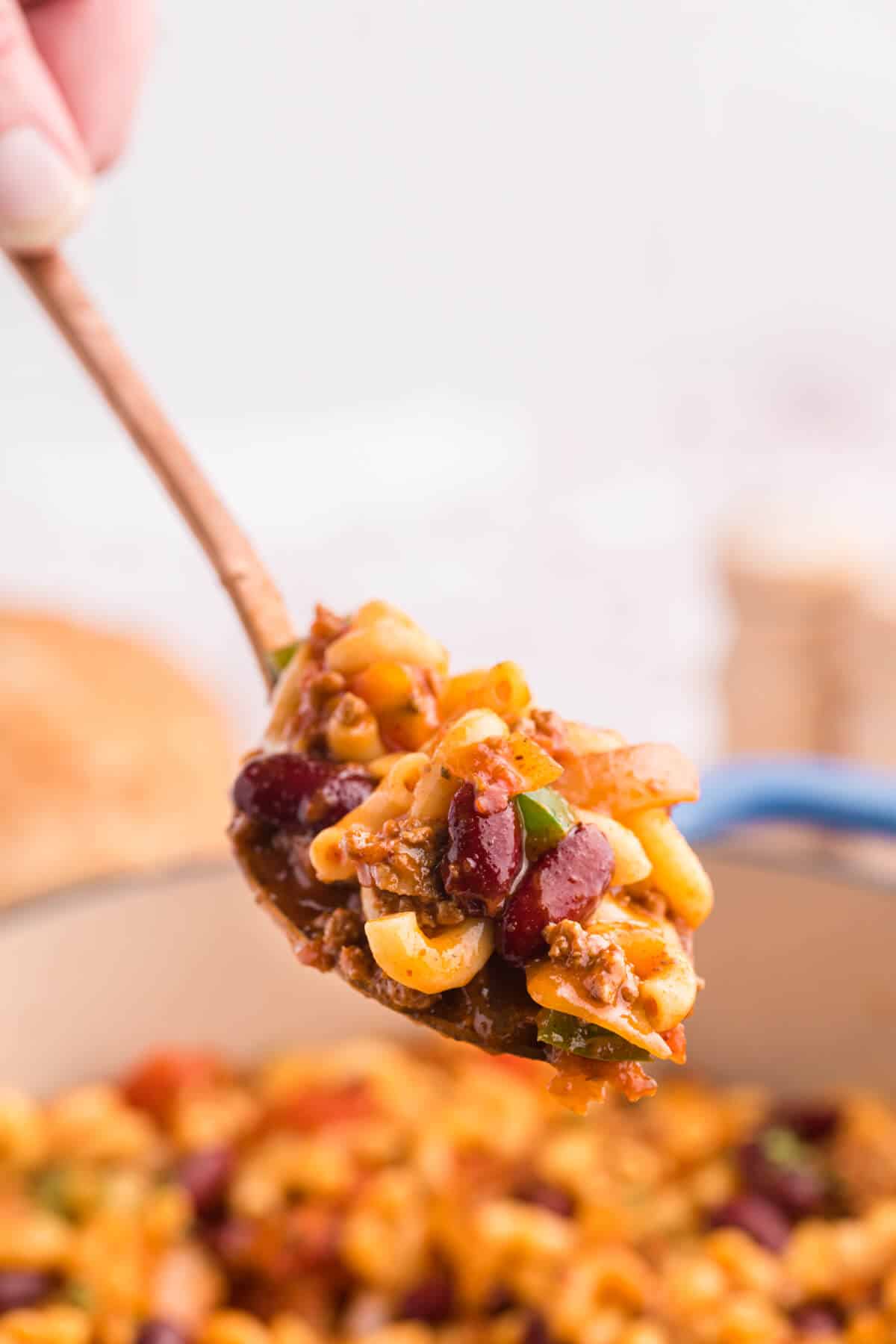 Chili macaroni on a serving spoon.