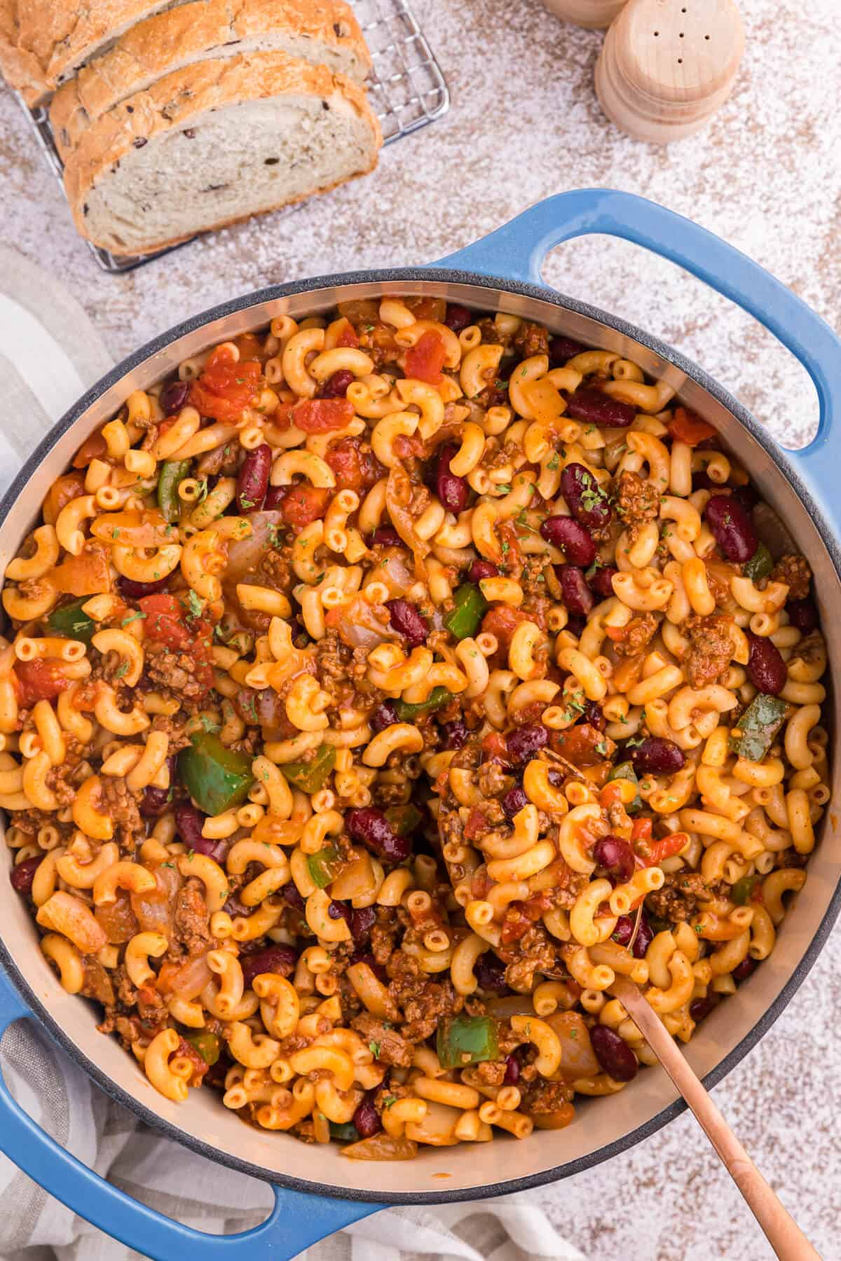 Chili macaroni in a pot with a serving spoon.