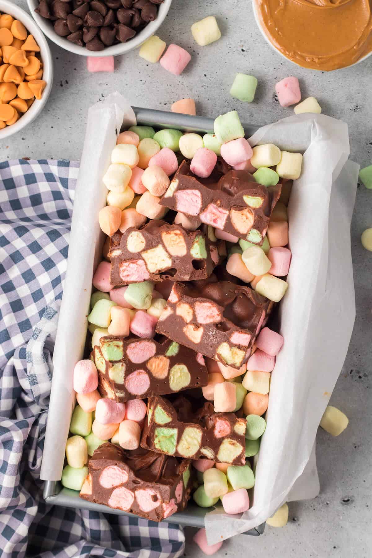 Chocolate confetti bars cut up in a loaf pan.