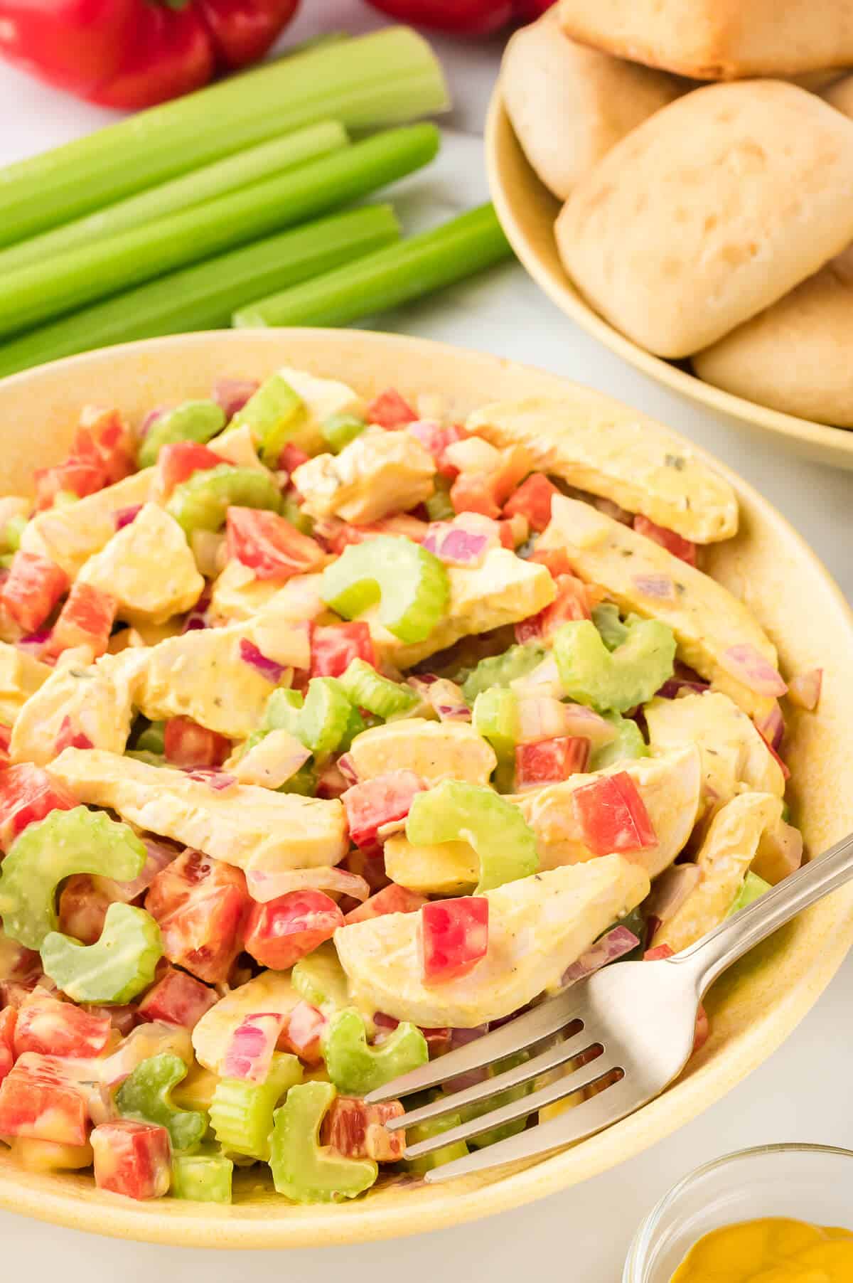 Mustard chicken salad in a bowl with a fork.