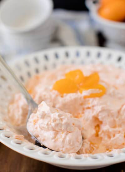 Orange Creamsicle Salad - The fluffiest dessert! You'll dream about your childhood ice cream cravings with this creamy fruit salad with cottage cheese, Jello, and mandarin oranges.