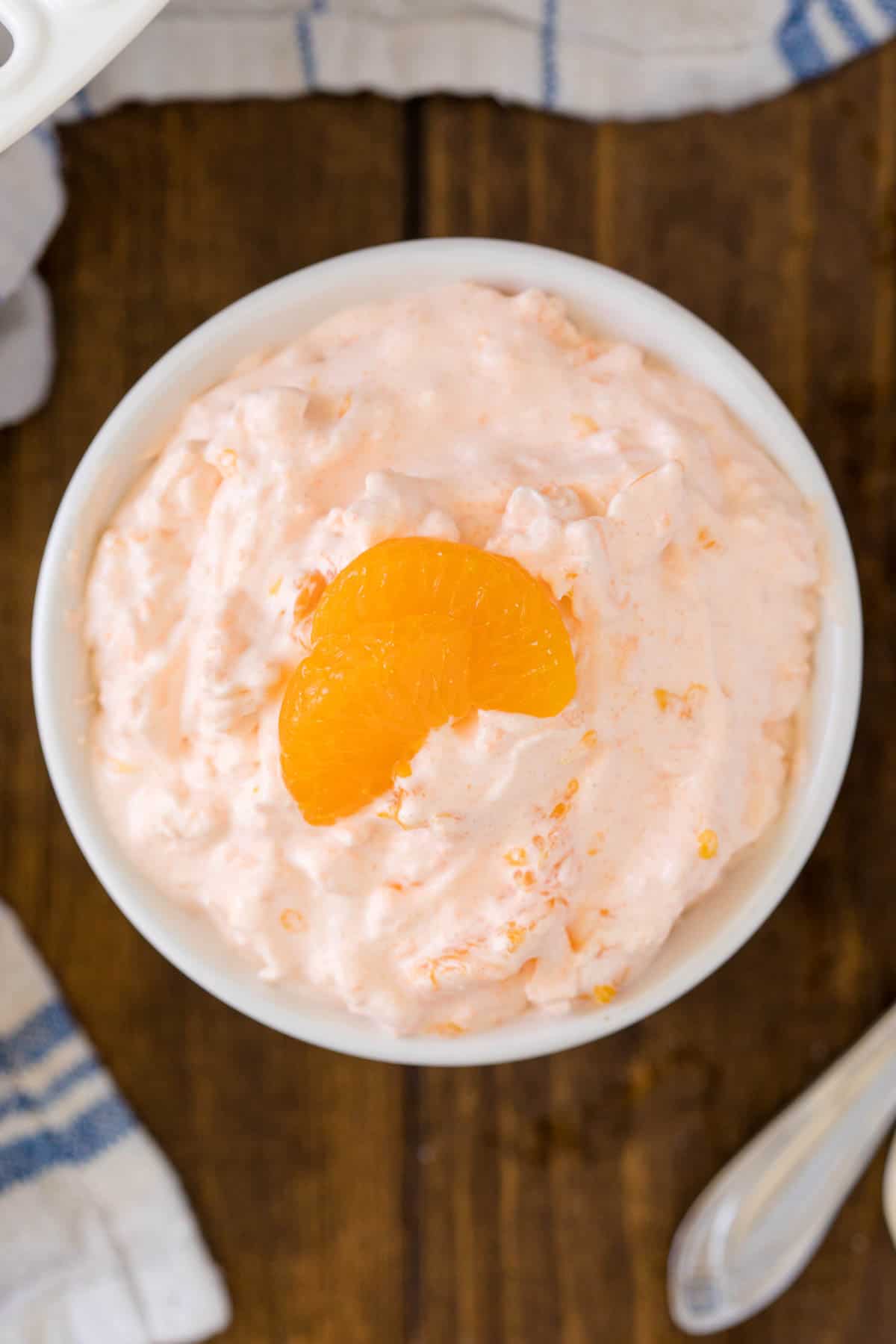 Orange Creamsicle Salad - The fluffiest dessert! You'll dream about your childhood ice cream cravings with this creamy fruit salad with cottage cheese, Jello, and mandarin oranges.