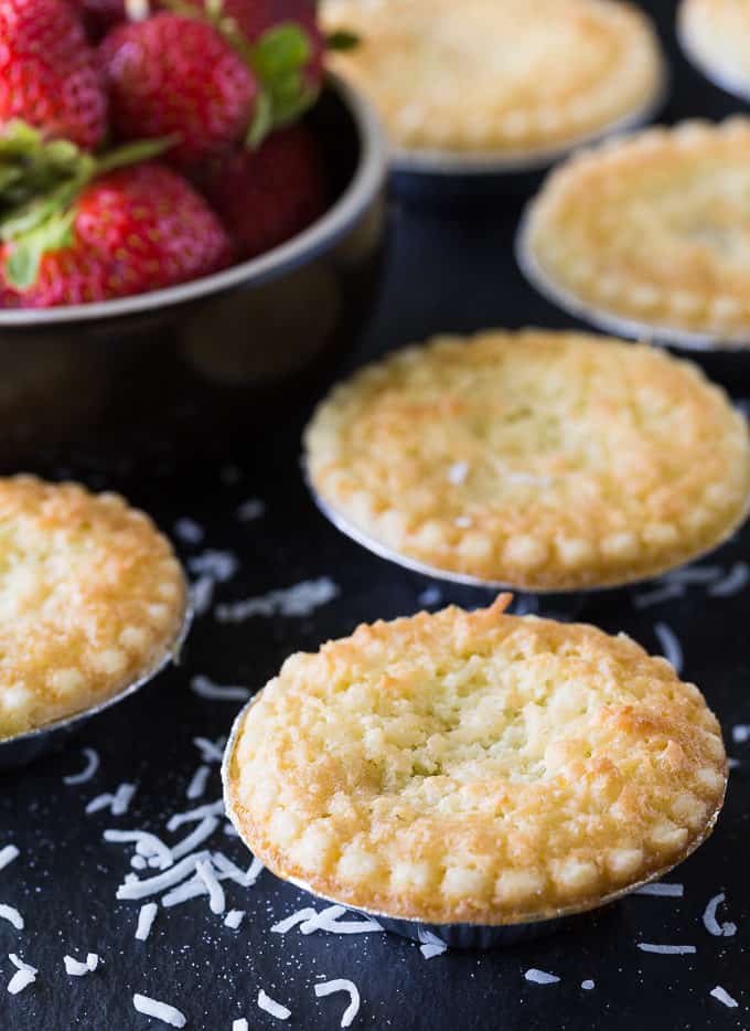 Strawberry Coconut Tarts - Tiny tarts perfect for parties! Strawberry jam is surrounded by a coconut pie.