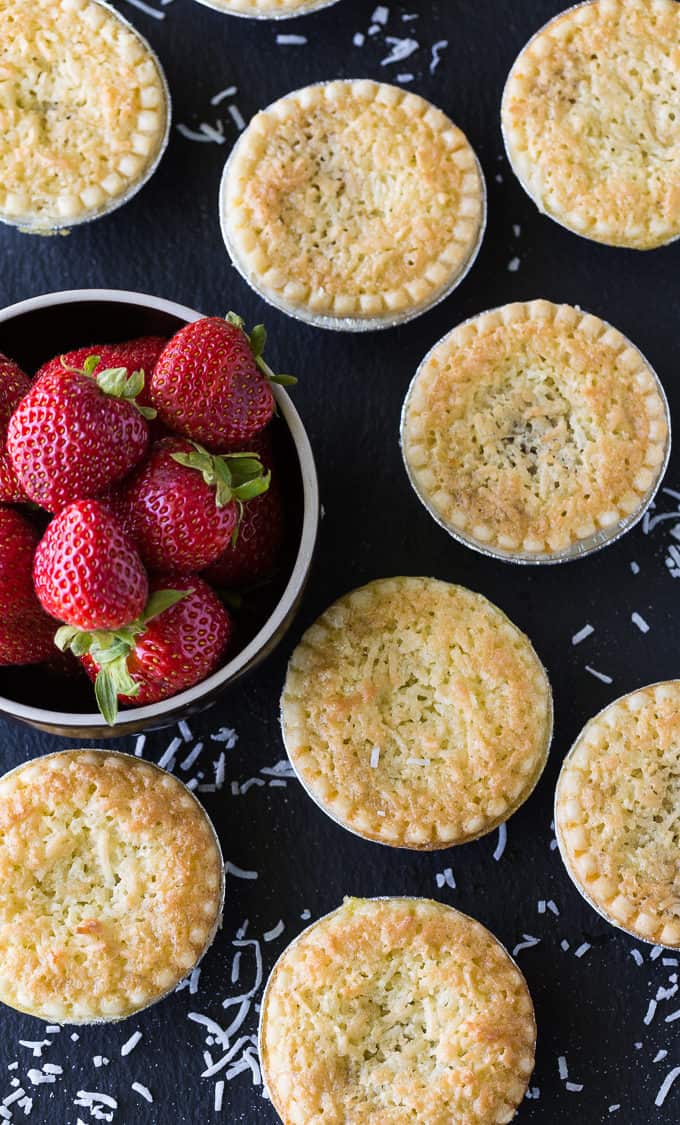 Strawberry Coconut Tarts - Tiny tarts perfect for parties! Strawberry jam is surrounded by a coconut pie.