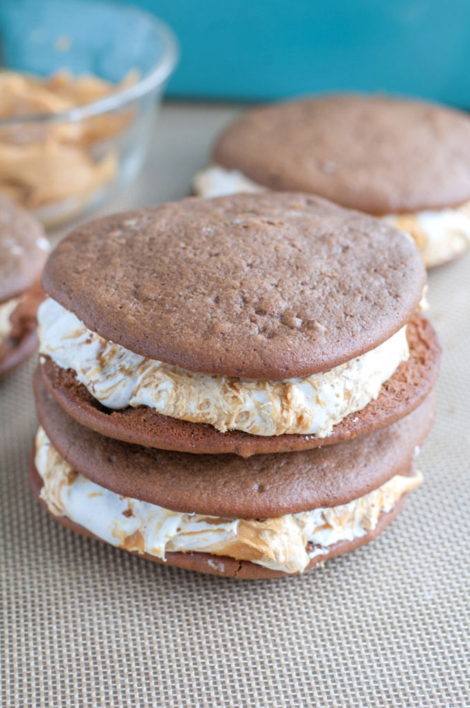 Chocolate Peanut Butter Whoopie Pies - A dessert lover's dream! Marshmallow fluff swirled with peanut butter sandwiched between two soft chocolate cookies. 