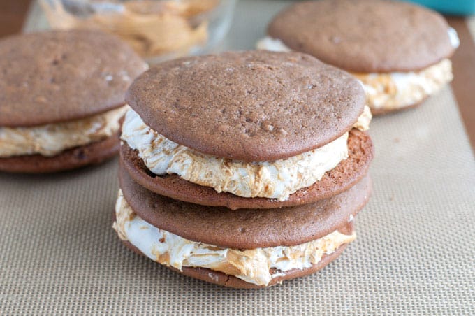 Chocolate Peanut Butter Whoopie Pies - A dessert lover's dream! Marshmallow fluff swirled with peanut butter sandwiched between two soft chocolate cookies. 
