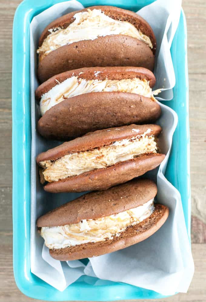 Chocolate Peanut Butter Whoopie Pies - A dessert lover's dream! Marshmallow fluff swirled with peanut butter sandwiched between two soft chocolate cookies. 
