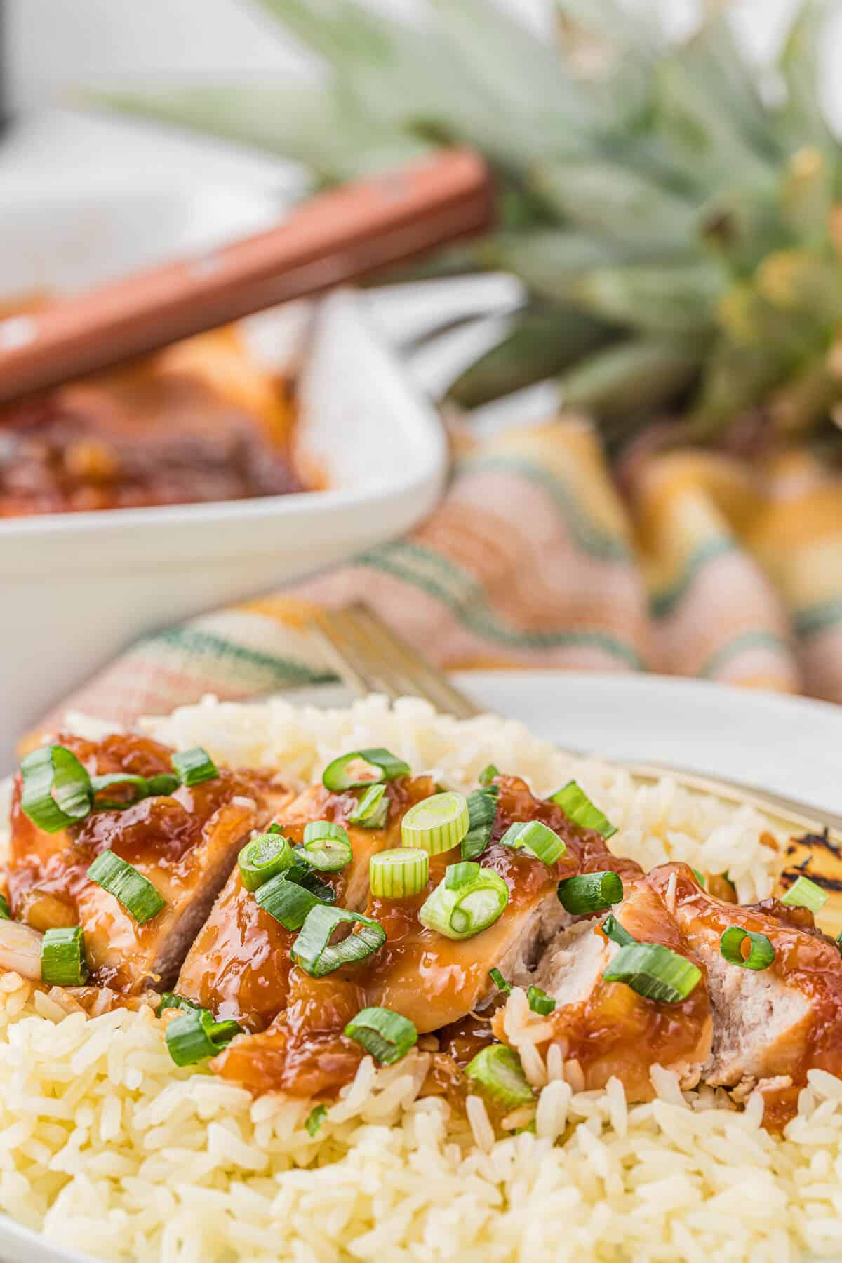 Hawaiian chicken cut in pieces on white rice.