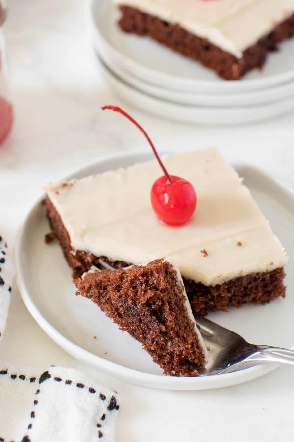 root beer float sheet cake on a plate with a piece taken off with a fork