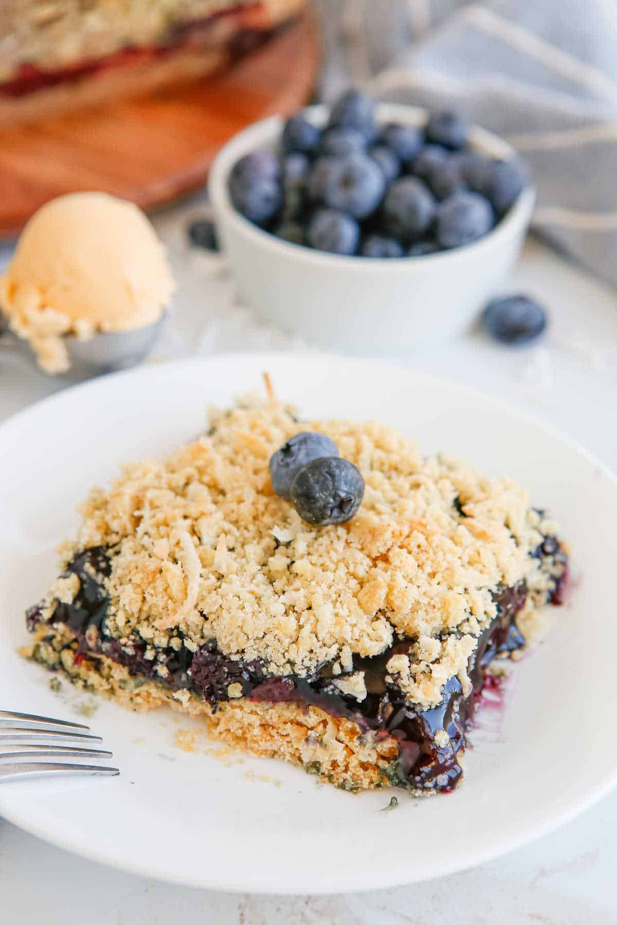 A piece of blueberry crackle cake on a plate.