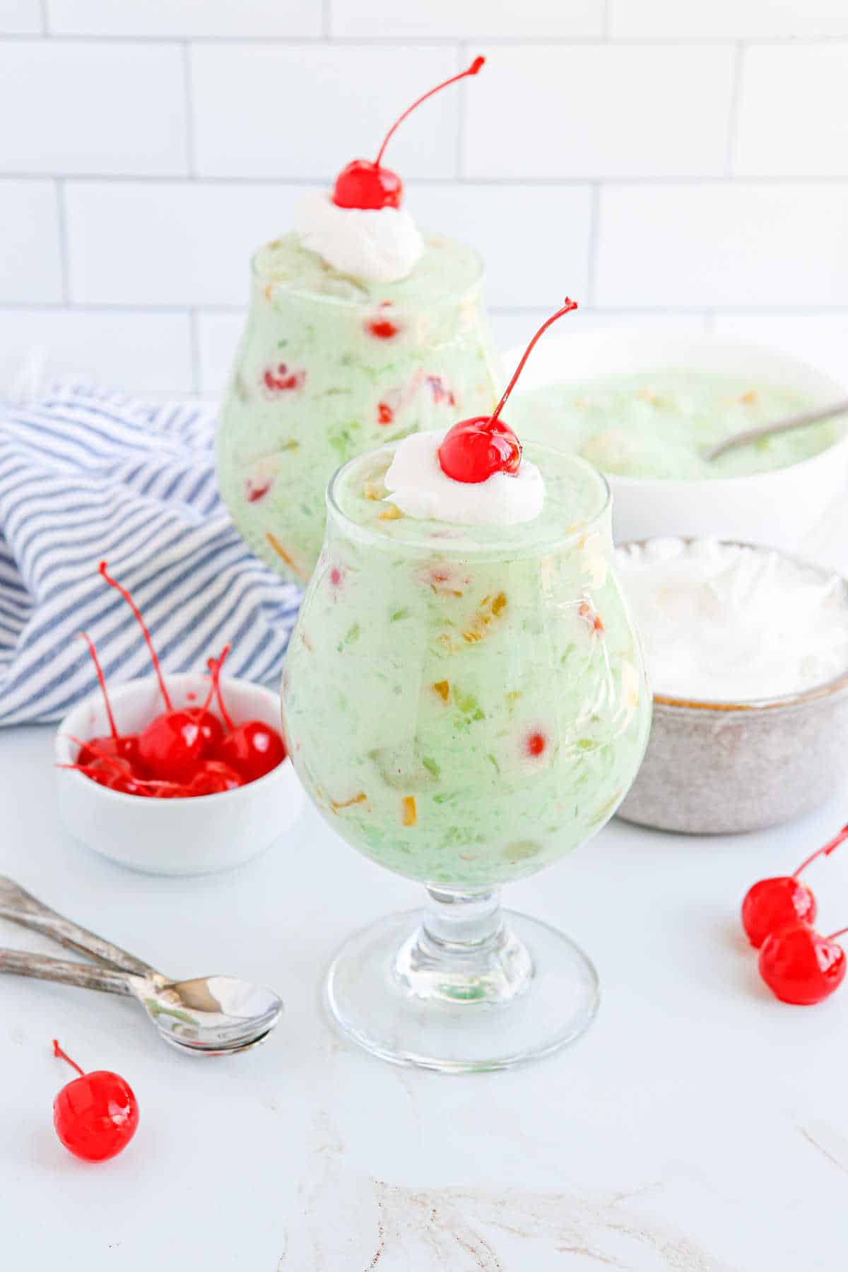 Fruit cocktail dessert in a parfait glass.