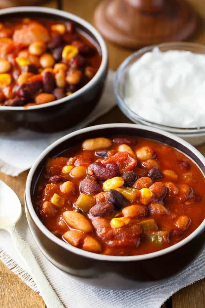 Bean Chili - The heartiest meat-free chili recipe! Use four different kinds of canned beans in this comfort food classic with peppers, corn, and tomatoes.