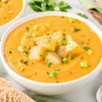 A bowl of carrot and potato soup.