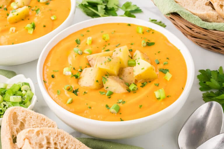 A bowl of carrot and potato soup.