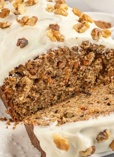 A carrot cake loaf with a slice cut off the end.