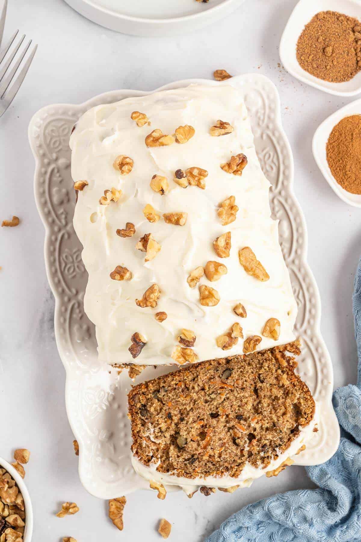 Carrot cake loaf with a slice cut off the end.