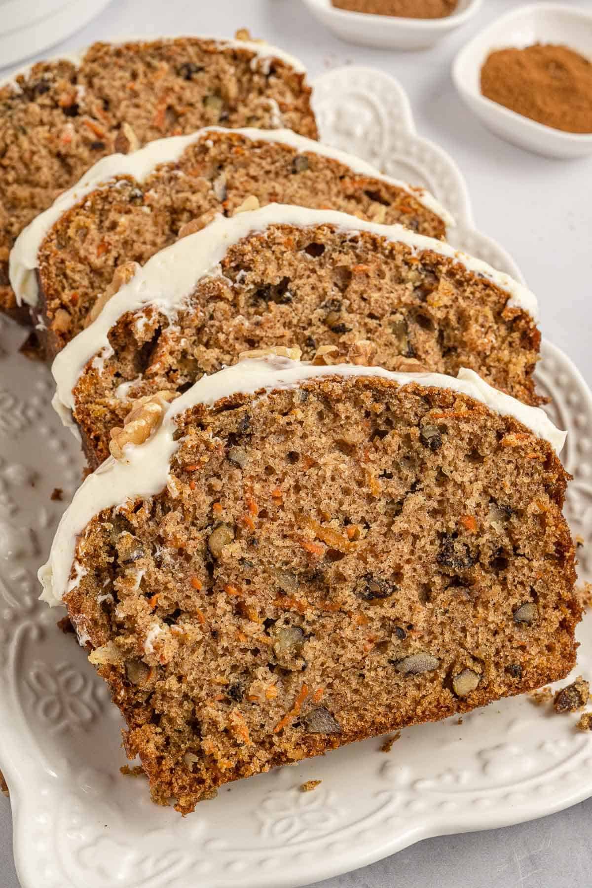 Slices of carrot cake loaf on a platter.